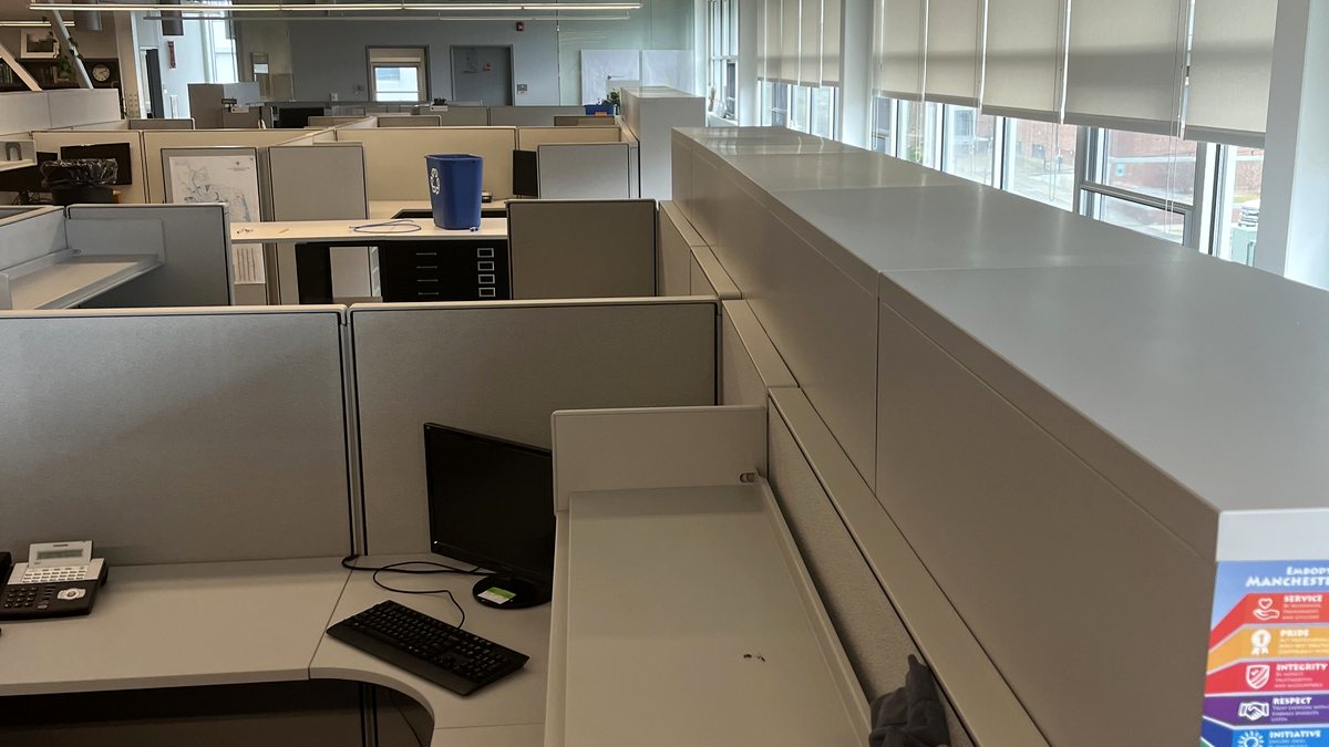 Existing workstations and overhead storage in an office being inventoried before a move