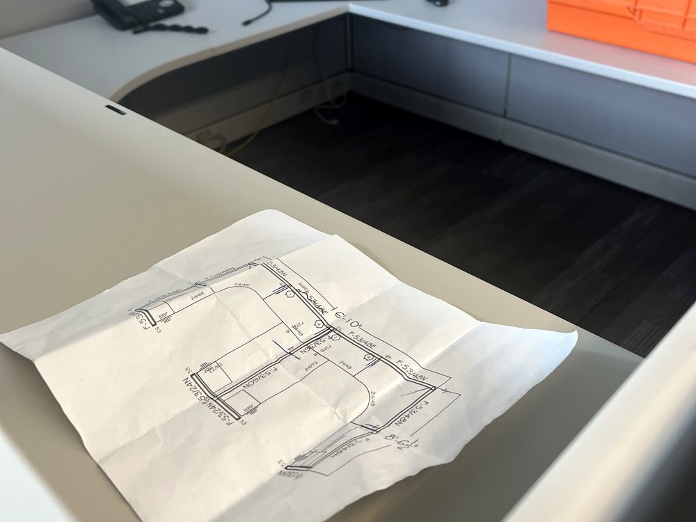 Marked-up furniture plan showing part codes and dimensions next to a rental moving crate